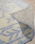 Louie Para Blue Hand Knotted Wool & Bamboo Silk Rug, showcasing a vibrant blue palette and intricate patterns, rests invitingly within a light-filled room.