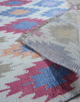 Sumptuous Majestic Multicolor Hand Knotted Wool & Bamboo Silk Rug, vibrant hues dancing across a luxuriously textured surface, hints of gold catching the light in a contemporary living space.