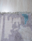 Iris Bianca Multicolor Hand Knotted Bamboo Silk Rug, a vibrant splash of color and luxurious texture, lies elegantly on a light hardwood floor, its intricate design and shimmering bamboo silk fibers catching the light.