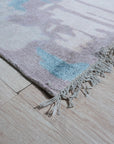 Iris Bianca Multicolor Hand Knotted Bamboo Silk Rug, a vibrant splash of color unfolds across a lustrous bamboo silk rug, its hand-knotted construction evident in the intricate design. Seen in a styled interior setting.