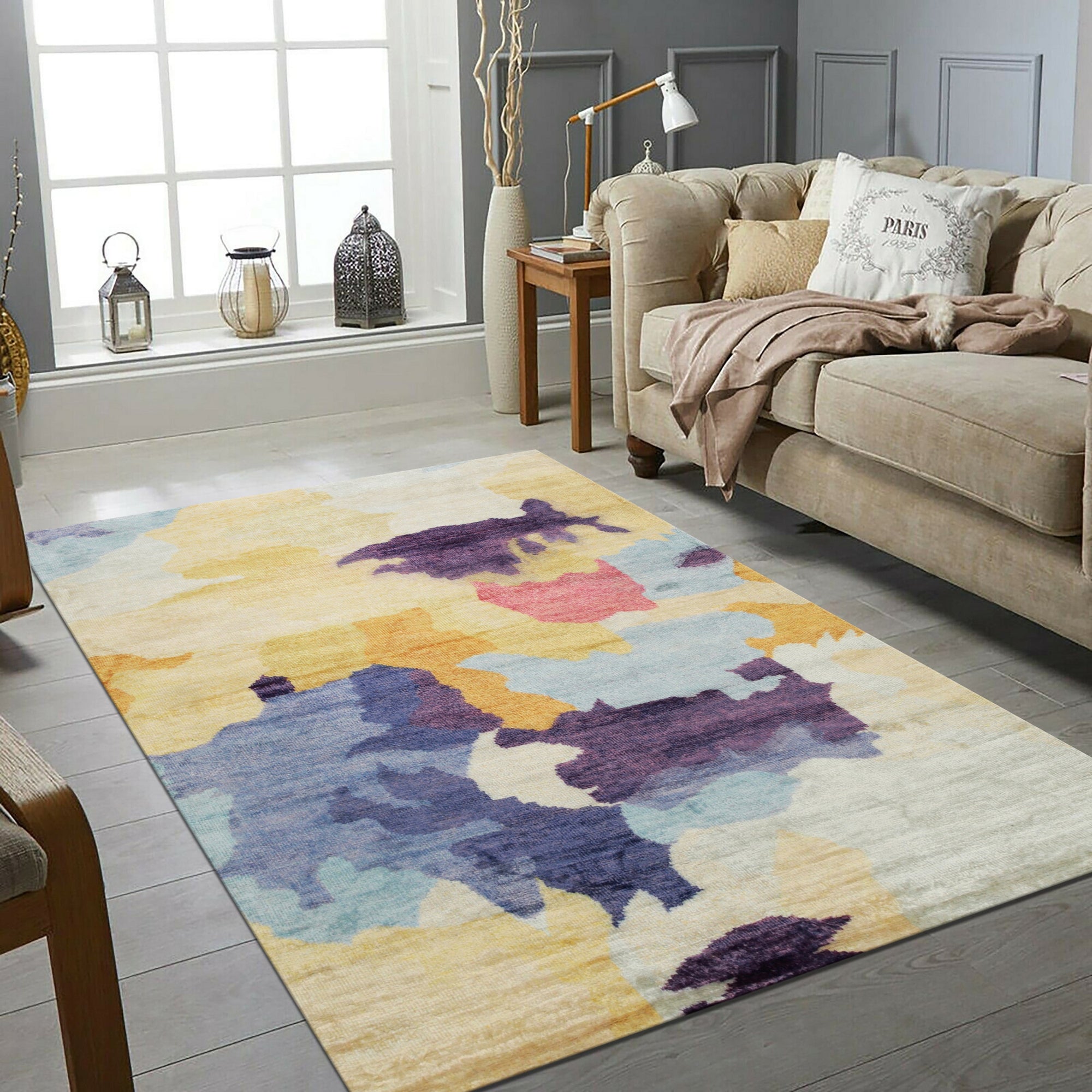 Fiona Trara Multicolor Handmade Bamboo Silk Rug, shimmering with vibrant hues, lies on a polished wooden floor, its luxurious bamboo silk fibers catching the light, showcasing a modern abstract design.