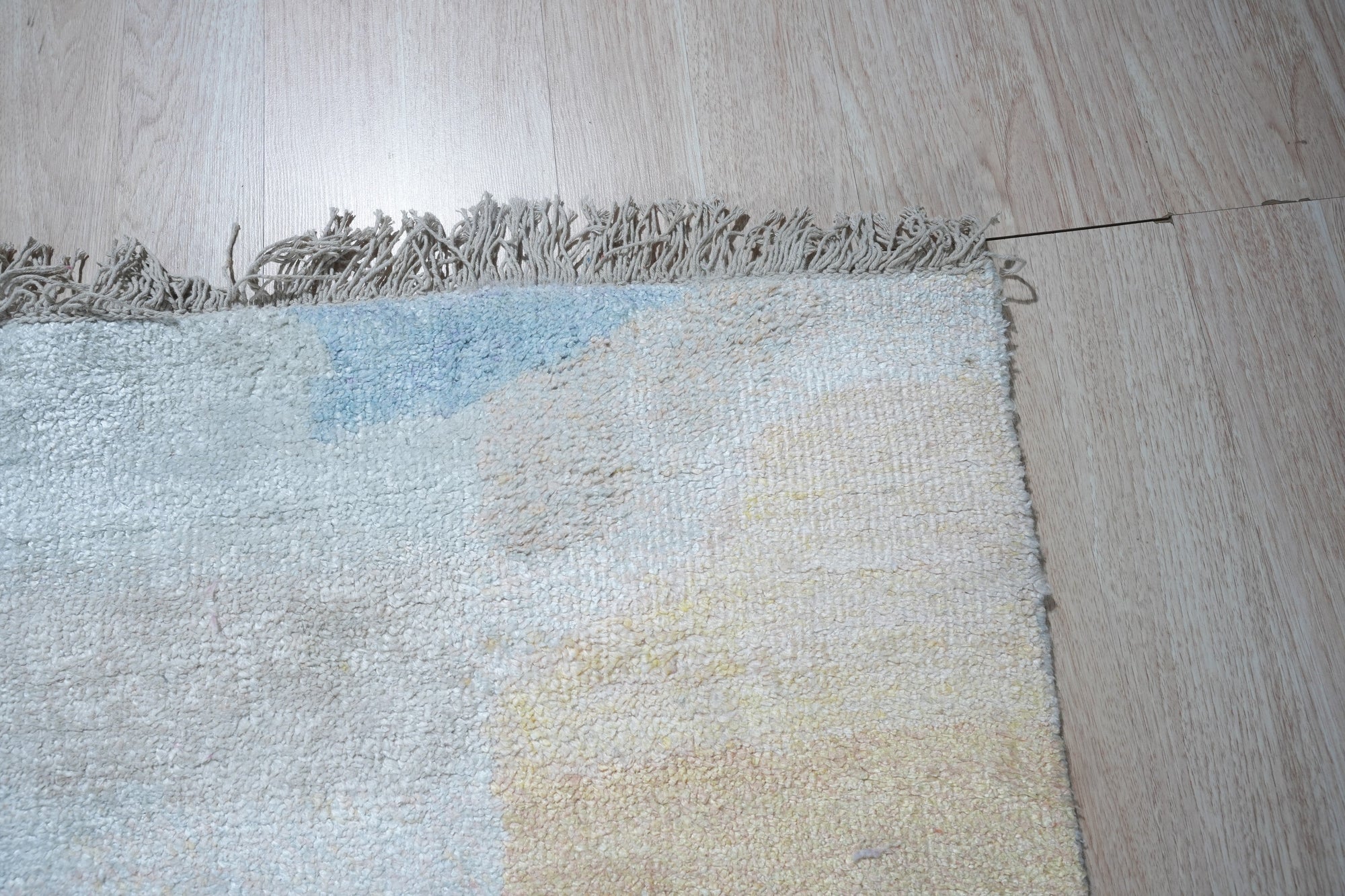 Fiona Trara Multicolor Handmade Bamboo Silk Rug, showcasing vibrant hues woven into a luxurious texture, displayed in a bright, modern living space.
