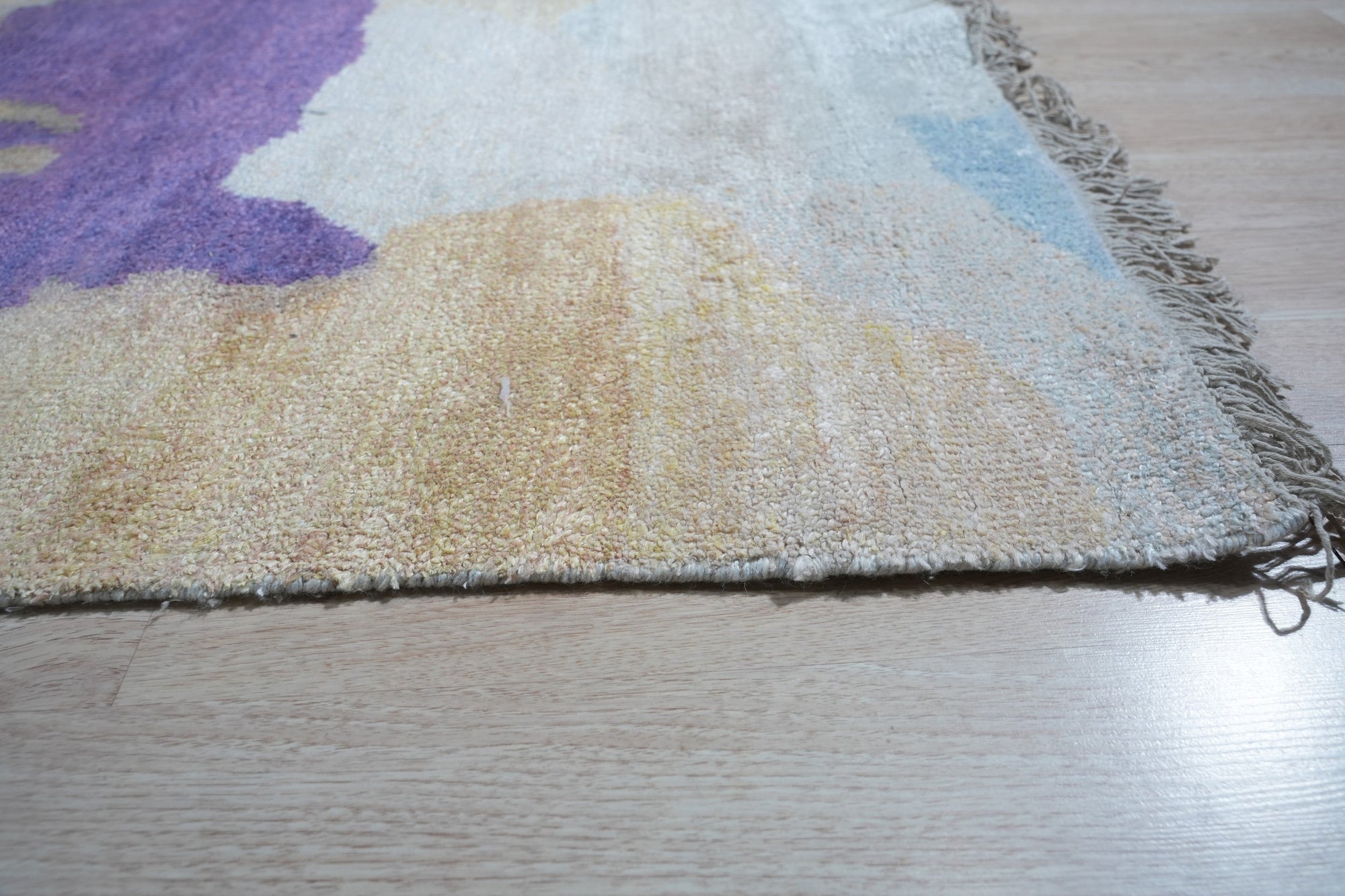 Fiona Trara Multicolor Handmade Bamboo Silk Rug, vibrant hues dance across its shimmering surface, hand-knotted bamboo silk creating a luxurious texture underfoot in a stylish living room setting.
