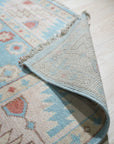 Yara Willow Light Blue Hand Knotted Wool Rug, soft light blue hues and intricate hand-knotted wool construction, laying elegantly in a bright, modern living space.
