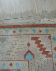 Penelope Traditional Rust Hand Knotted Wool Rug, detailed central medallion and intricate border in warm rust and earthy tones, hand knotted for luxurious texture and durability, rests on a dark wood floor creating a classic, inviting atmosphere.