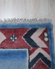 Willow Talia Blue Hand Knotted Wool Rug, a cool-toned blue wool rug with a subtly textured, distressed design, complementing a modern living room setting with light wood floors and neutral furniture.