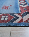 Willow Talia Blue Hand Knotted Wool Rug, blending cool blues in an intricate, hand-knotted wool design, enhancing a warmly lit room.