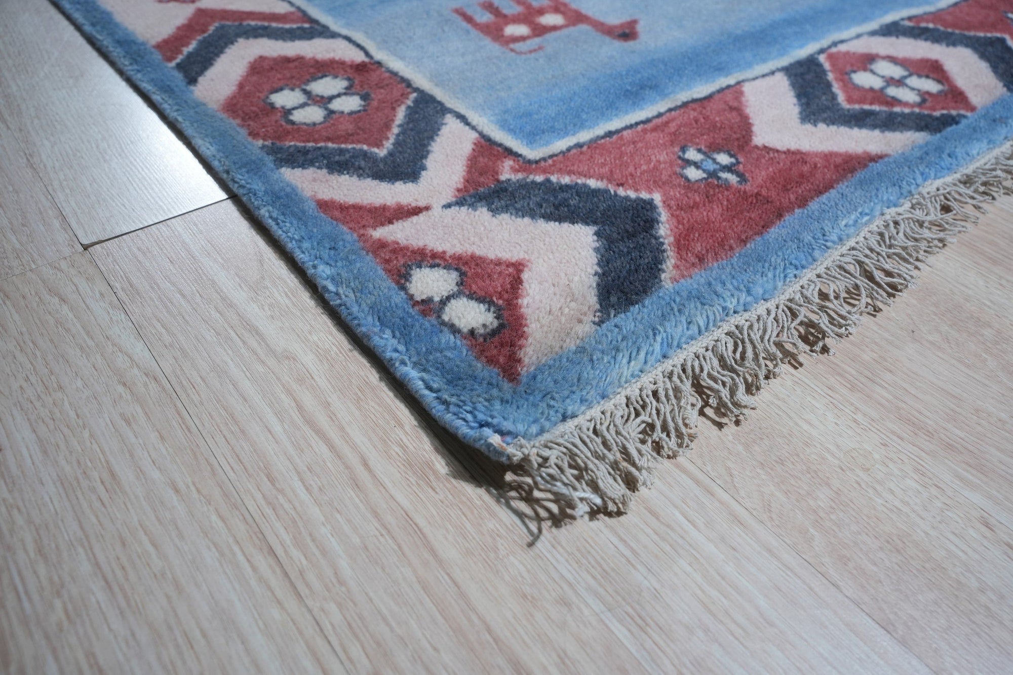 Willow Talia Blue Hand Knotted Wool Rug, showcasing intricate patterns woven in varying shades of blue on a neutral background, adding depth and texture to a living space.