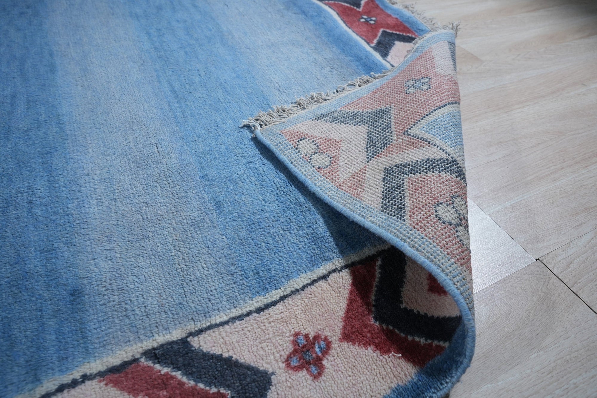 Willow Talia Blue Hand Knotted Wool Rug, showcasing intricate patterns in shades of blue and cream, seen in a bright, airy living room setting.