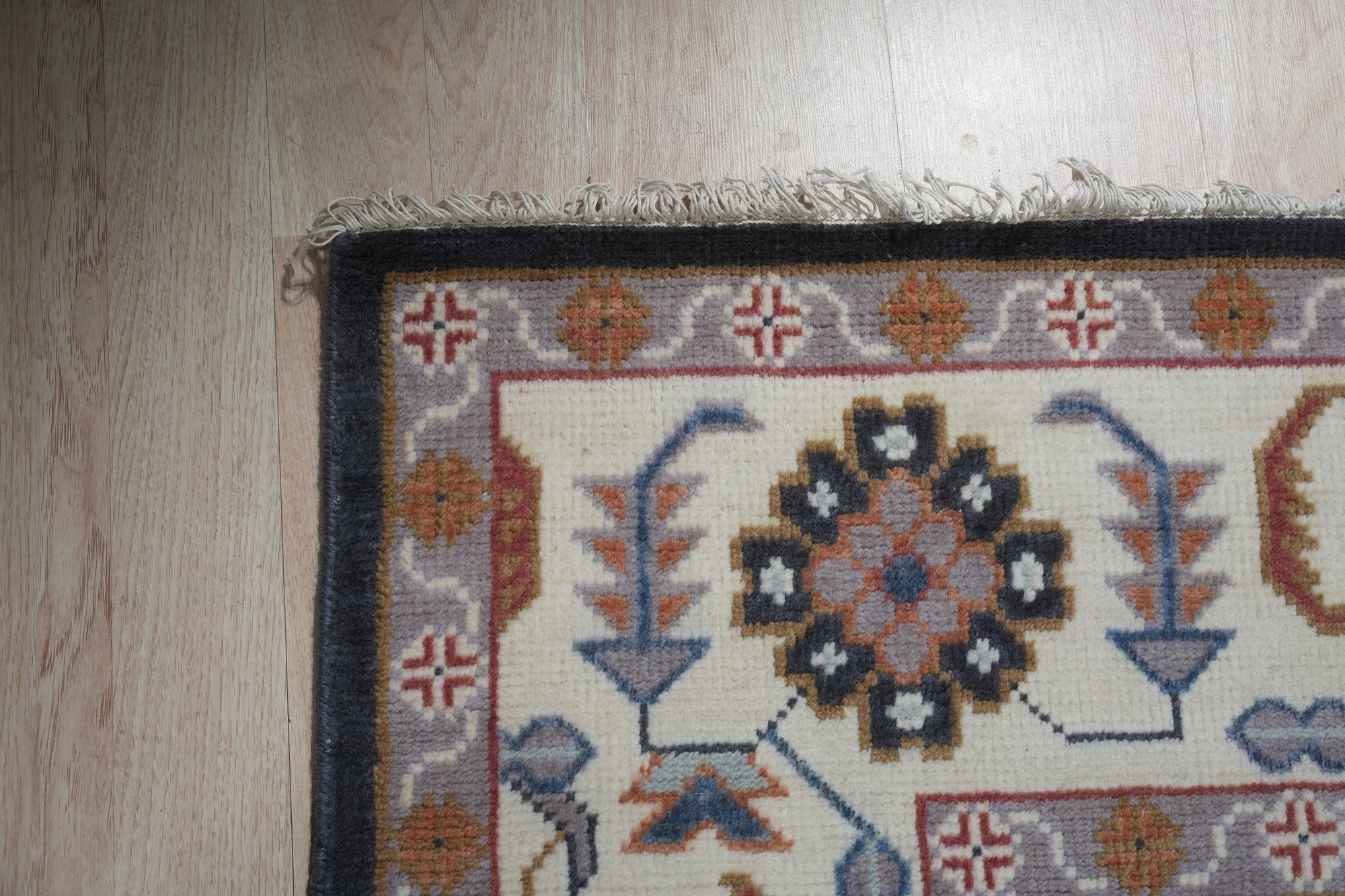 Refined Oushak Charcoal Hand Knotted Wool Rug, a charcoal wool rug with a traditional Oushak design, seen in a bright living space with a light-colored sofa.
