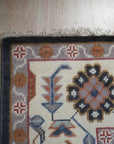 Refined Oushak Charcoal Hand Knotted Wool Rug, a charcoal wool rug with a traditional Oushak design, seen in a bright living space with a light-colored sofa.