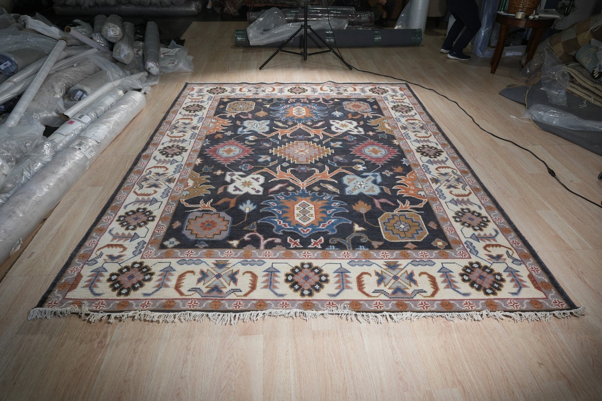 Refined Oushak Charcoal Hand Knotted Wool Rug, its charcoal hues and hand-knotted wool construction displayed in a staged living room setting.