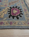 Tessa Laine Blue Hand Knotted Wool Rug, a textured expanse of interwoven wool, displaying intricate knotwork in cool blue tones, softly illuminated in a warm, inviting room setting.