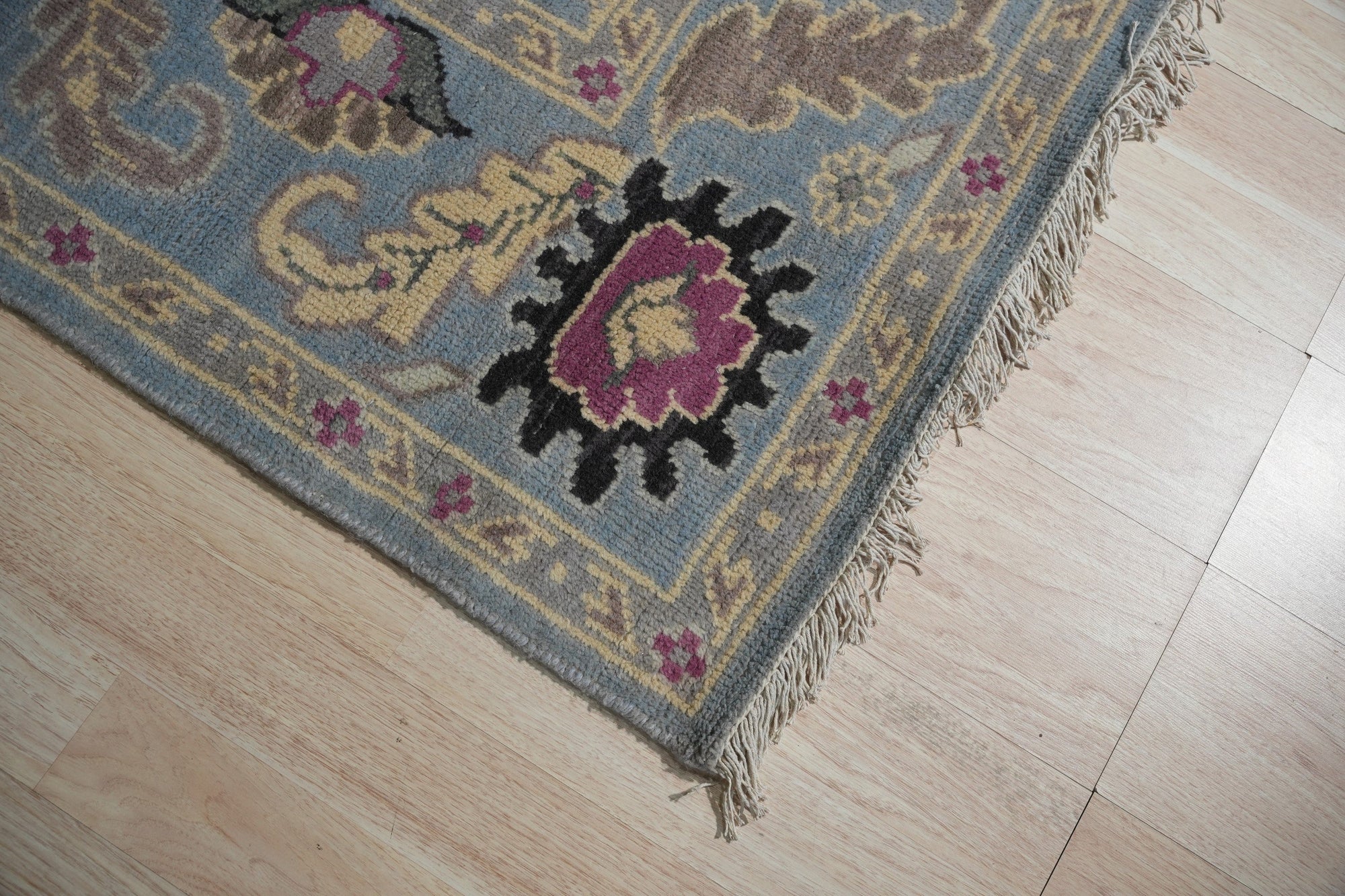 Tessa Laine Blue Hand Knotted Wool Rug, featuring a subtle, textured pattern in varying shades of blue, displayed in a bright, modern living room setting.