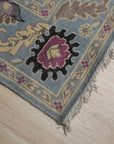 Tessa Laine Blue Hand Knotted Wool Rug, featuring a subtle, textured pattern in varying shades of blue, displayed in a bright, modern living room setting.