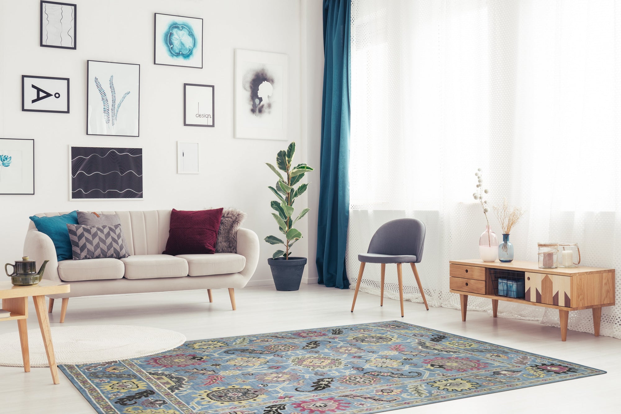 Tessa Laine Blue Hand Knotted Wool Rug, its intricate pattern and rich blue hues anchoring a living room space with a neutral sofa and warm wooden floor, showcasing its hand-knotted construction and soft texture.