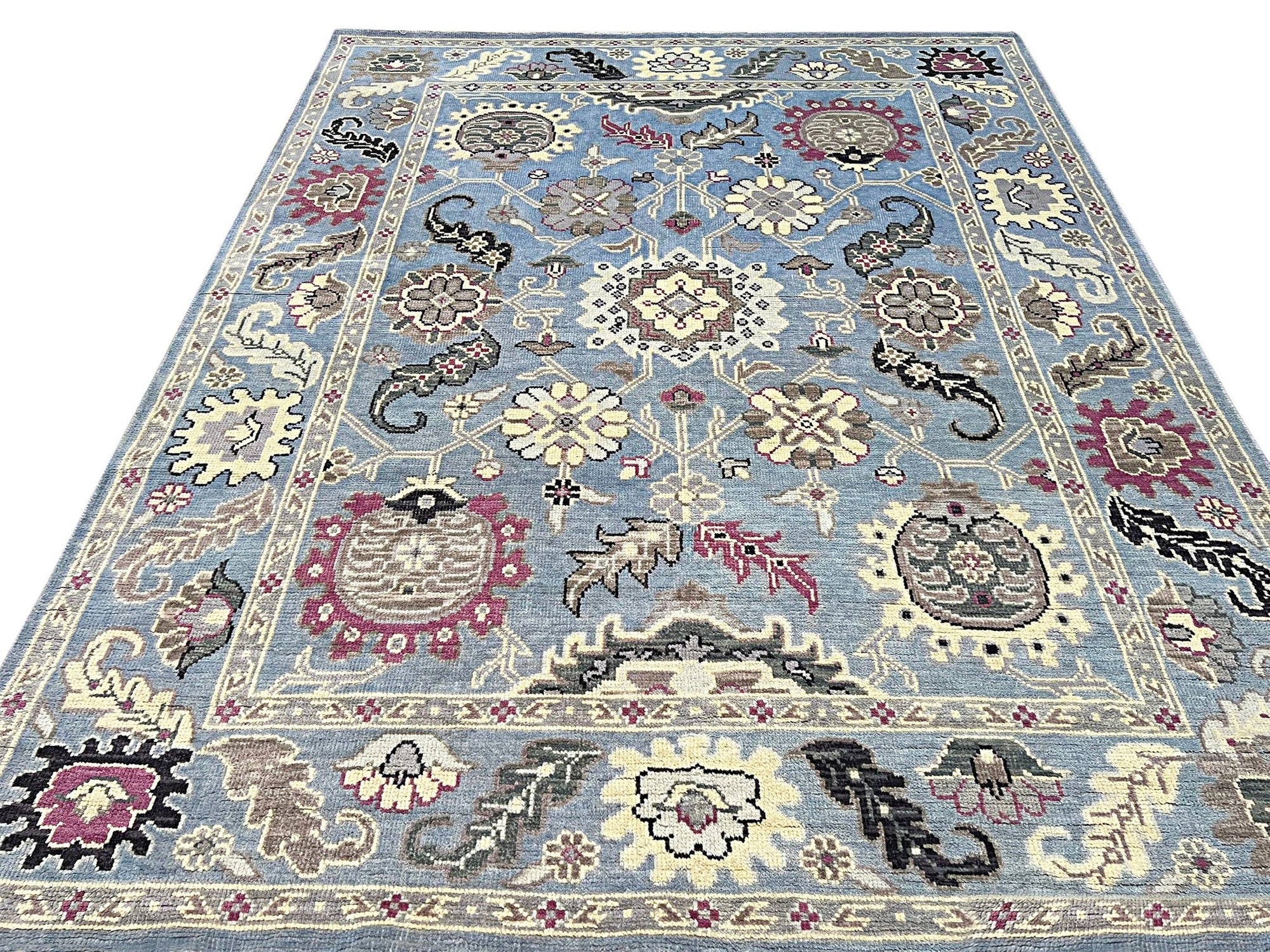 Willow Radiant Light Blue Nan Rug, light blue textured rug with a subtle sheen, displayed on a light hardwood floor, suggesting modern comfort and style.