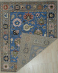 Nina Penelope Blue Nan Rug, showcasing a textured weave with geometric patterns in varying shades of blue, ivory, and charcoal gray. The rug's soft pile and subtle sheen create a welcoming and stylish atmosphere in the home.