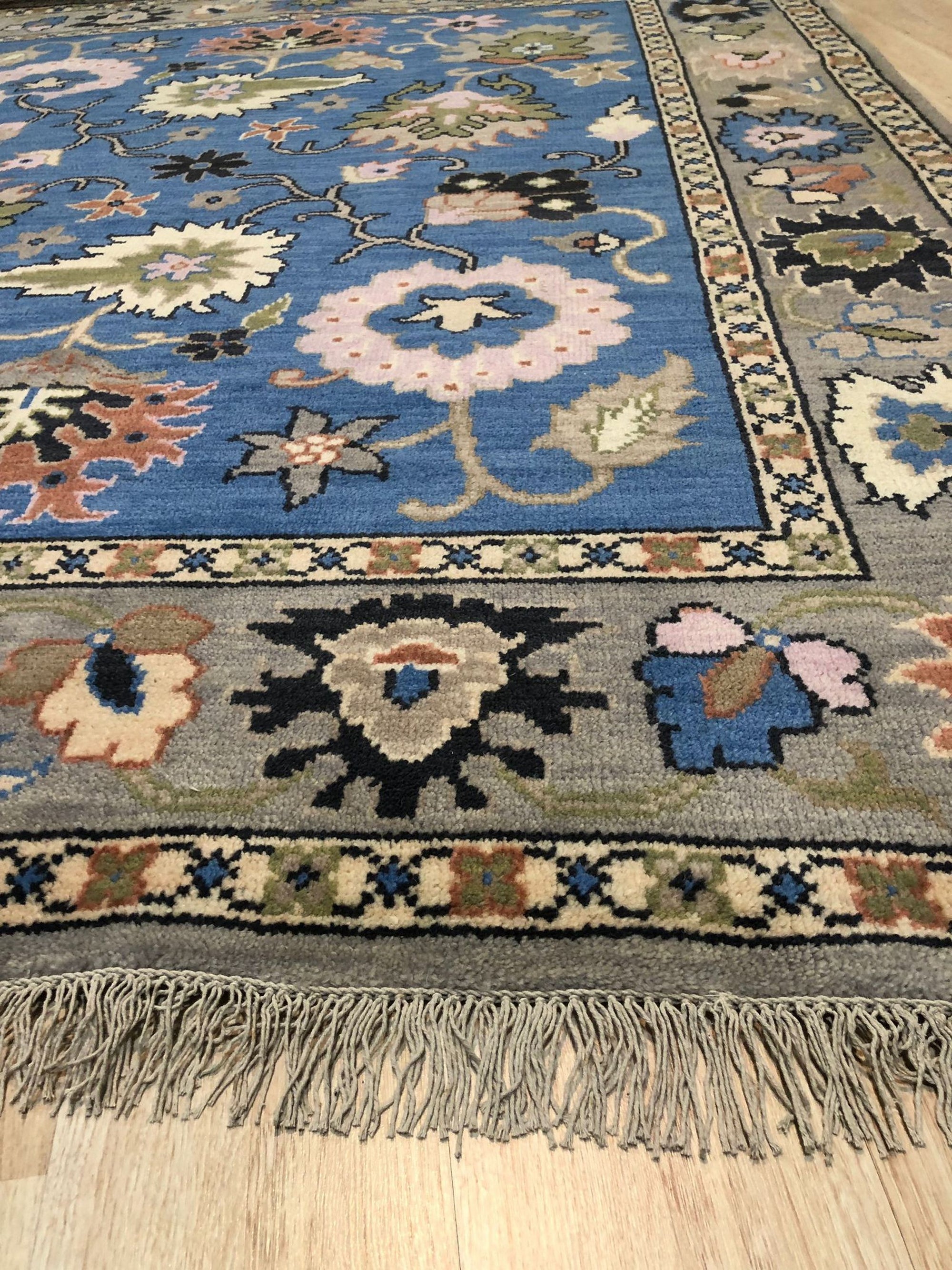 Nina Penelope Blue Nan Rug, geometric patterns dance across a soft blue field, woven with a subtle texture that invites touch, creating a calming yet contemporary foundation.