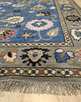 Nina Penelope Blue Nan Rug, geometric patterns dance across a soft blue field, woven with a subtle texture that invites touch, creating a calming yet contemporary foundation.