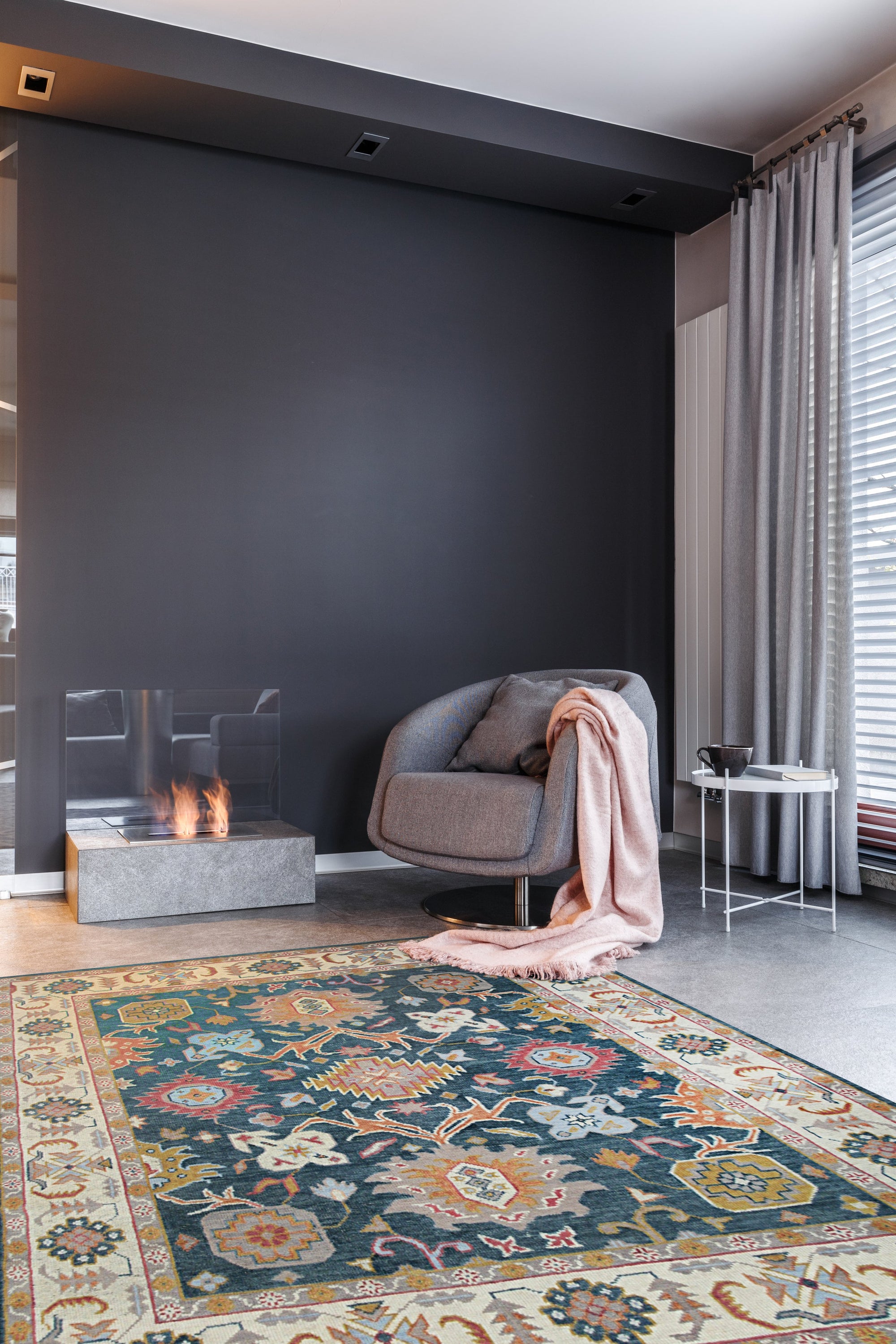 Sarrah Oushak Charcoal Hand Knotted Wool Rug, showcasing a soft charcoal palette and intricate Oushak design, lies elegantly in a well-lit living room.