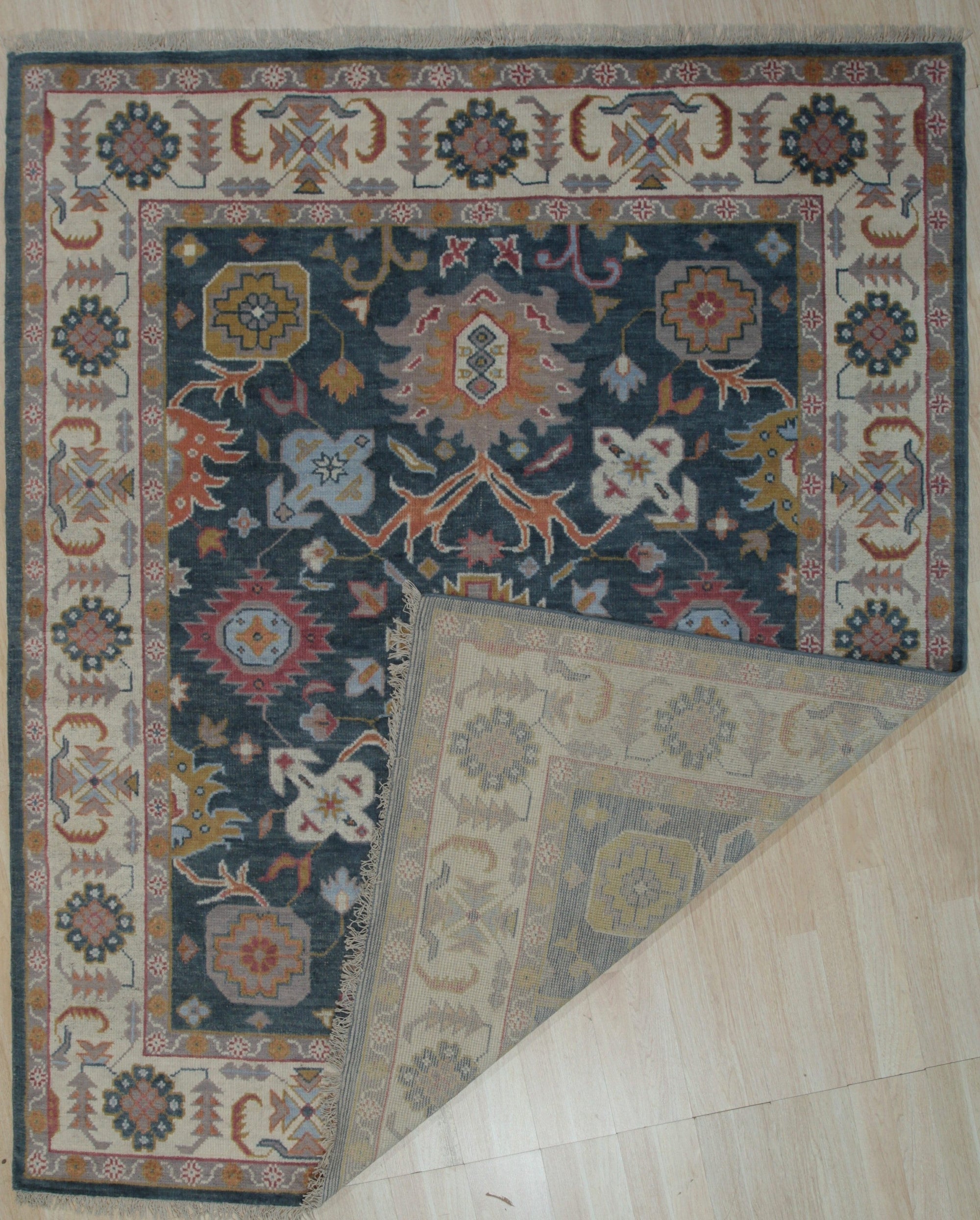 Sarrah Oushak Charcoal Hand Knotted Wool Rug, its intricate, faded charcoal design adding timeless elegance to a well-lit living space.