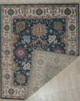 Sarrah Oushak Charcoal Hand Knotted Wool Rug, its intricate, faded charcoal design adding timeless elegance to a well-lit living space.