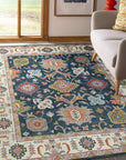 Sarrah Oushak Charcoal Hand Knotted Wool Rug, muted charcoal tones and intricate floral patterns unfolding across hand-knotted wool, enriching a softly lit living space.