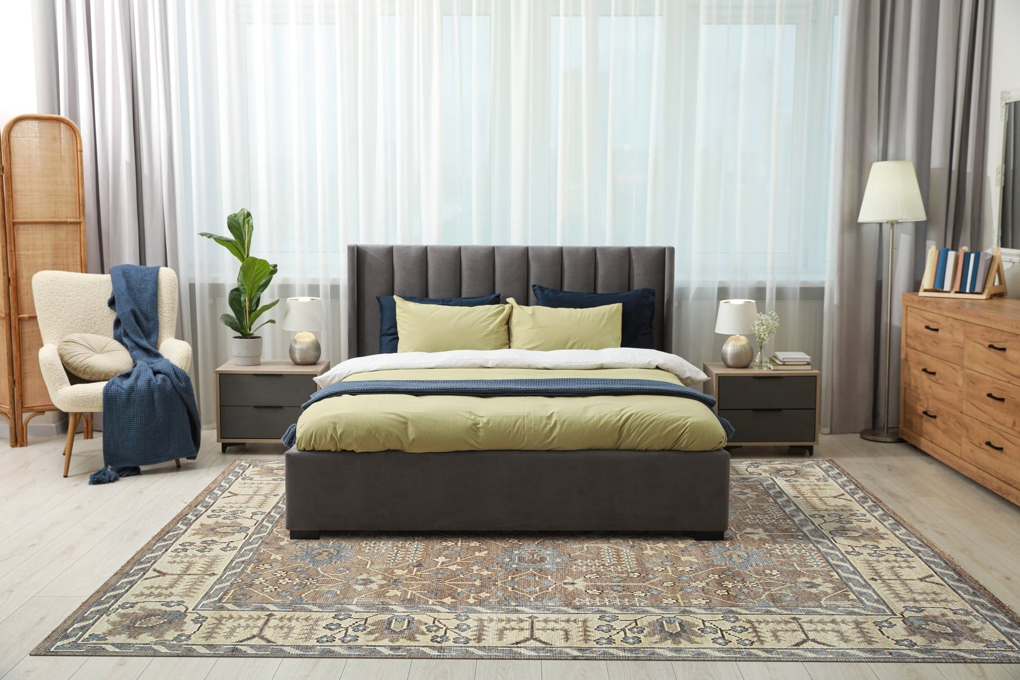 Lydia Sophisticated Brown Hand Knotted Wool Rug, showcasing a detailed, geometric pattern in shades of brown, cream, and gray, laid on a light wooden floor in a well-lit room.