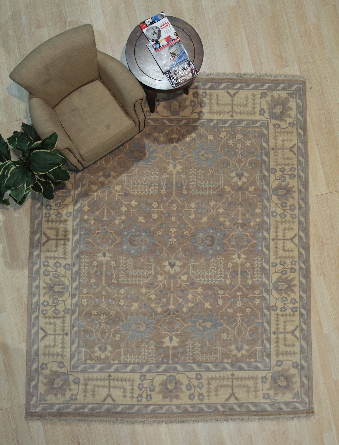 Lydia Sophisticated Brown Hand Knotted Wool Rug, its intricate pattern unfolding in warm browns and creams across hand-knotted wool fibers, bringing sophisticated texture to a light-filled room.