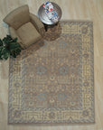 Lydia Sophisticated Brown Hand Knotted Wool Rug, its intricate pattern unfolding in warm browns and creams across hand-knotted wool fibers, bringing sophisticated texture to a light-filled room.