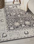 Cozy Oushak Charcoal Hand Knotted Wool Rug, a charcoal wool rug with an Oushak design, partially visible and hinting at its texture and craftsmanship.