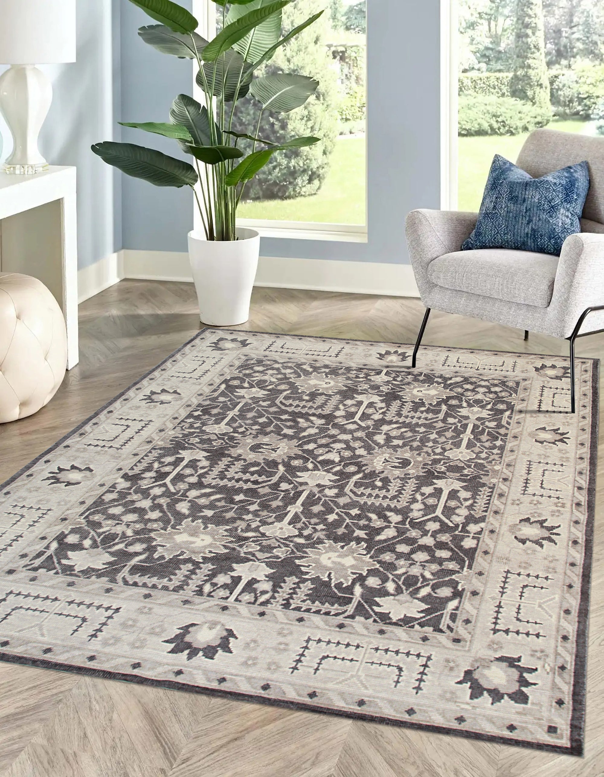 Cozy Oushak Charcoal Hand Knotted Wool Rug, a charcoal wool rug with a traditional Oushak design, displayed in a well-lit room with natural light.