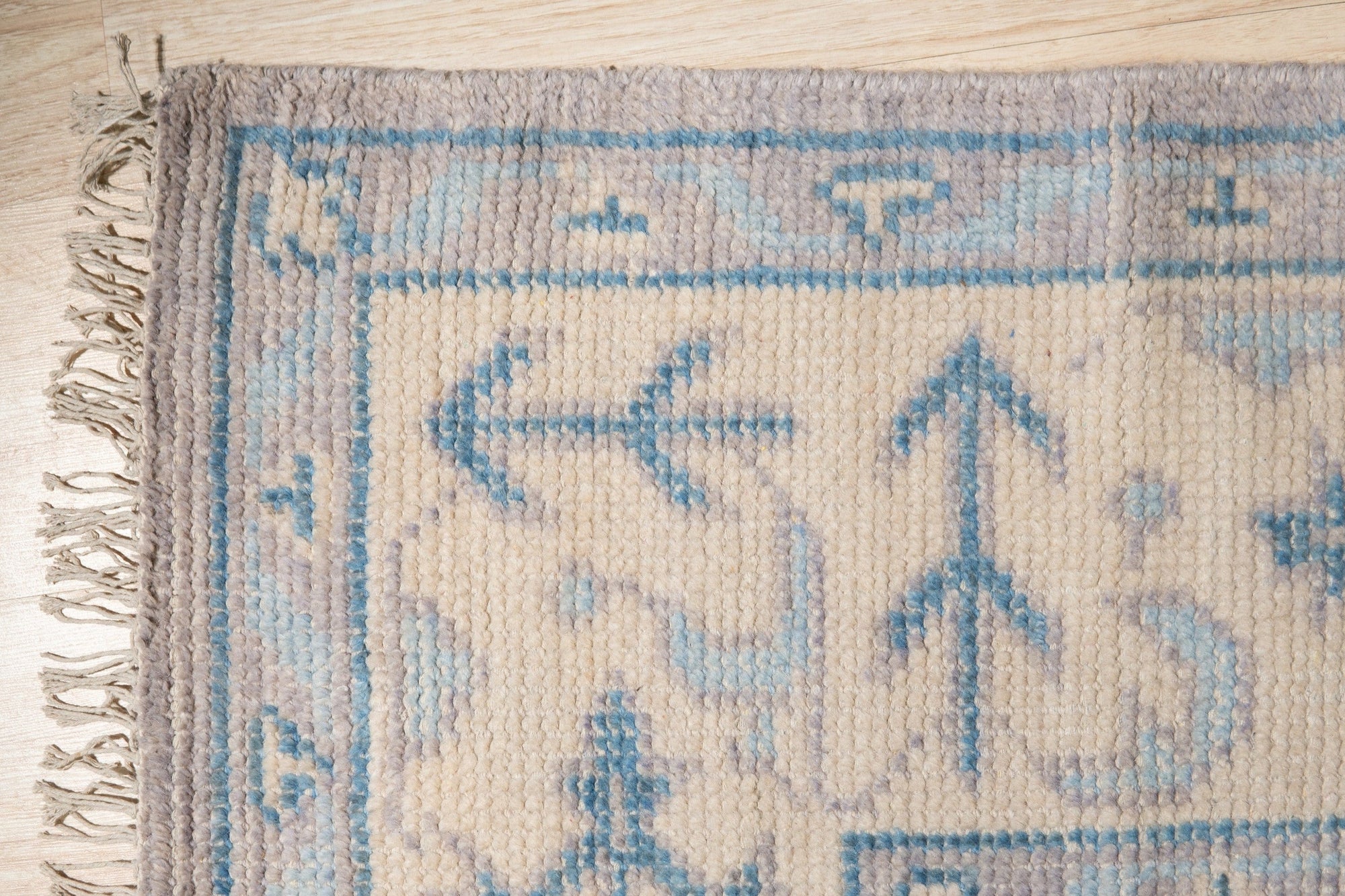 Selene Oushak Rust Hand Knotted Wool Rug, its intricate Oushak design in warm rust tones grounding a light-filled living space, showcasing textures and subtle color variations within the hand-knotted wool.