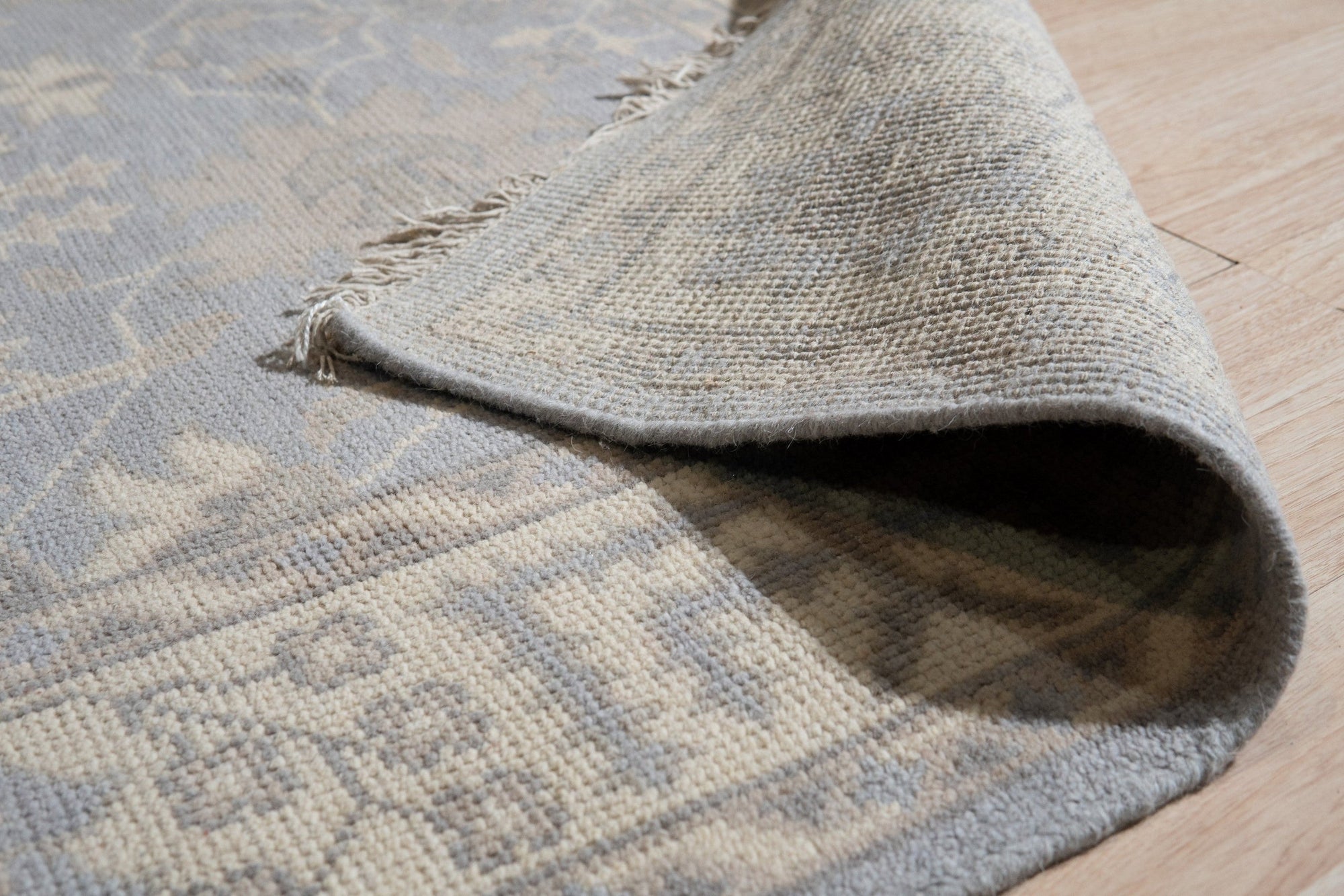 Selene Oushak Rust Hand Knotted Wool Rug, a rust-toned wool rug featuring a traditional Oushak design with floral and geometric motifs, adding warmth and texture to a well-lit room.