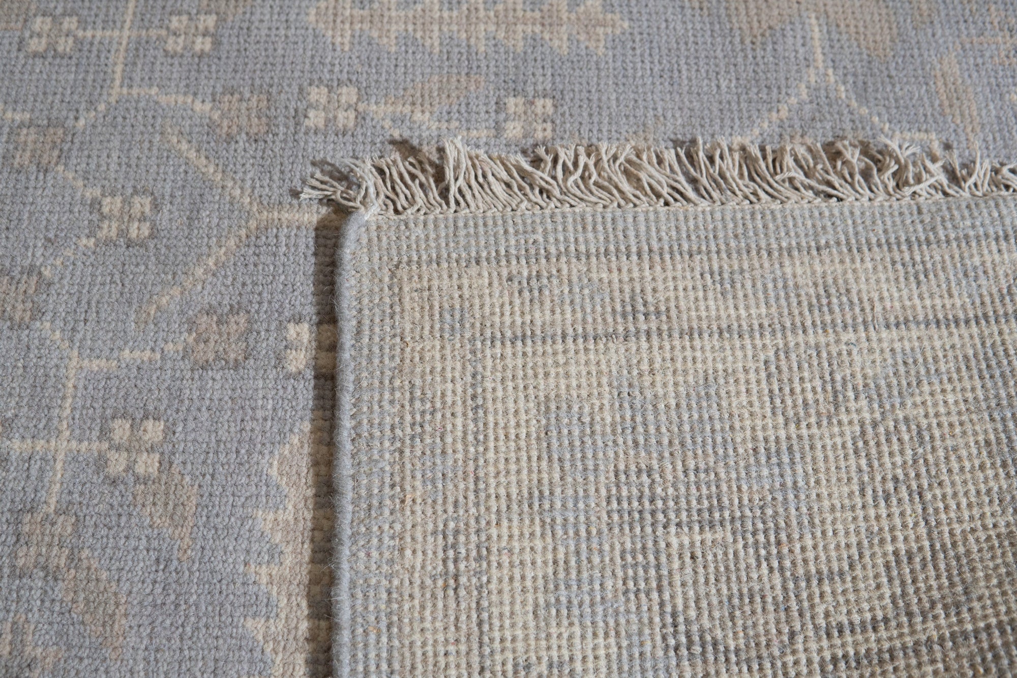 Selene Oushak Rust Hand Knotted Wool Rug, a rust-toned wool rug featuring a traditional Oushak design with intricate floral motifs and a subtly distressed texture, displayed in a bright interior setting.