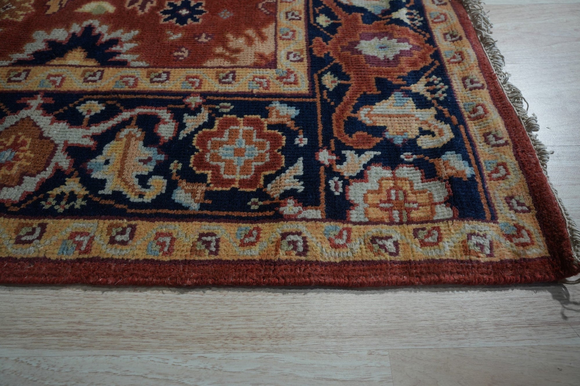 Majestic Versatile Red Hand Knotted Wool Rug, a vibrant red wool rug with intricate hand-knotted detailing, displayed in a warm, inviting interior setting.