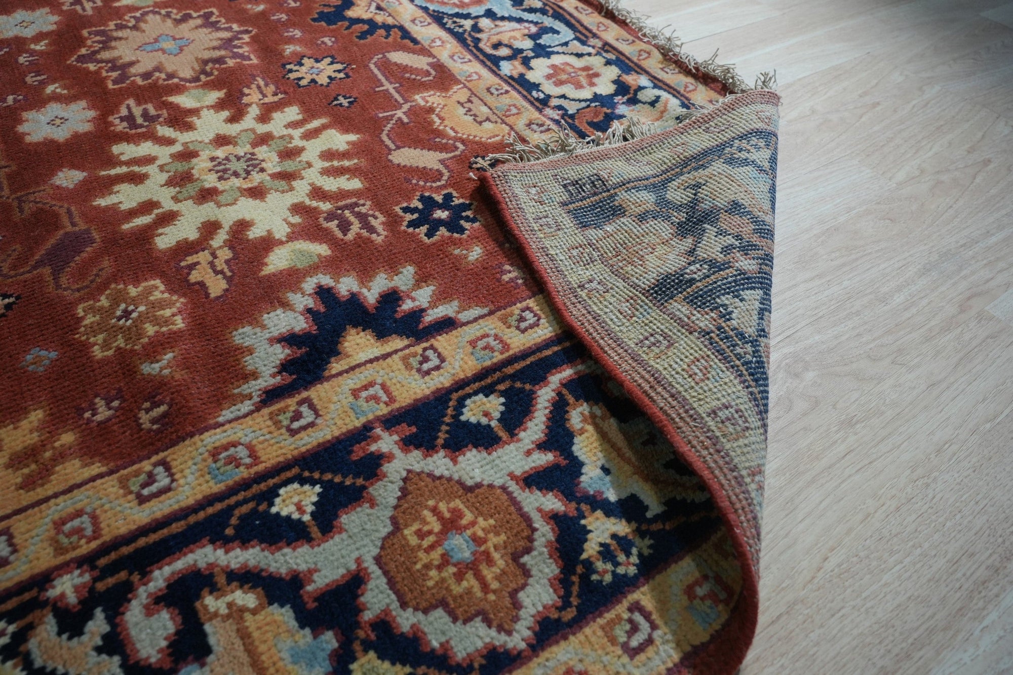 Majestic Versatile Red Hand Knotted Wool Rug, vibrant red wool rug displaying intricate hand-knotted craftsmanship, shown within a bright, modern interior setting.