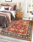 Kira Zinnia Rust Hand Knotted Wool Rug, featuring intricate patterns and rich red hues, partially displayed, showcasing texture and craftsmanship.