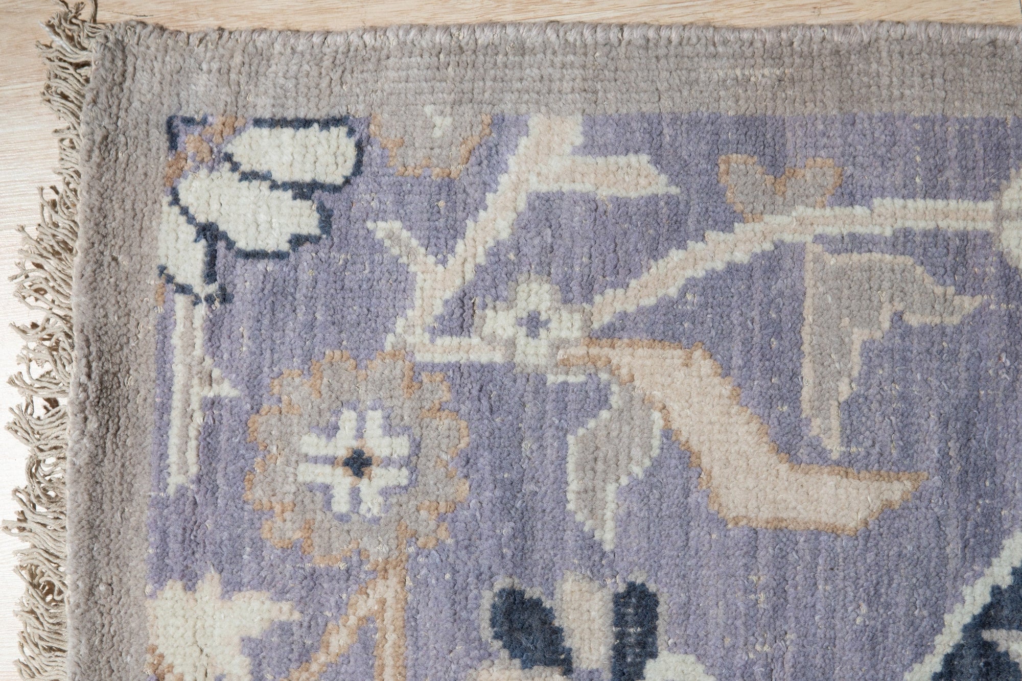 Timeless Oriental Ivory Hand Knotted Wool Rug displayed: muted ivory tones and intricate patterns visible in a detail shot highlighting the hand-knotted construction.