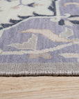 Timeless Oriental Ivory Hand Knotted Wool Rug, showcasing intricate floral patterns and geometric borders in soft ivory tones, lying flat on a light surface emphasizing the handcrafted detail.