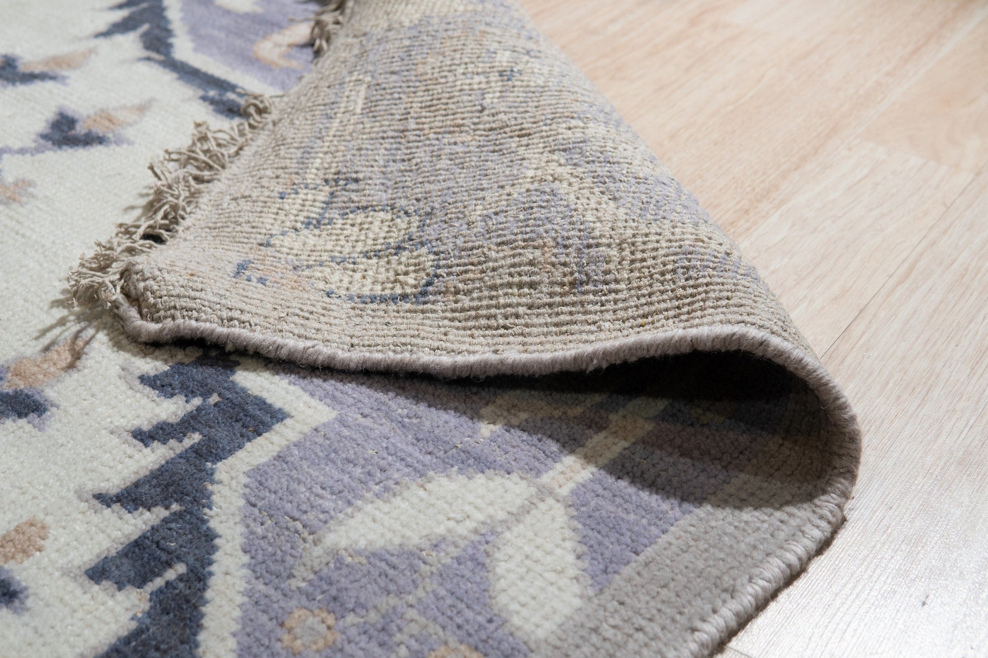 Timeless Oriental Ivory Hand Knotted Wool Rug, its intricate floral design and subtle ivory hues complementing a warmly lit interior.