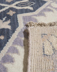 Timeless Oriental Ivory Hand Knotted Wool Rug, with intricate floral medallions and a neutral ivory palette, softly illuminates a living room setting, highlighting the rug's texture and detail.