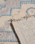 Iris Bianca Gray Hand Knotted Wool Rug, a calming gray wool rug with subtle variations in tone, adding depth and texture to a light-filled room.