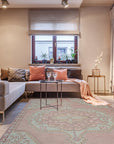 Lydia Oriental Pink Hand Knotted Wool Rug, warm hues bloom in a detailed oriental pattern. Crafted from hand-knotted wool, a pink and cream masterpiece anchors a bright living space.