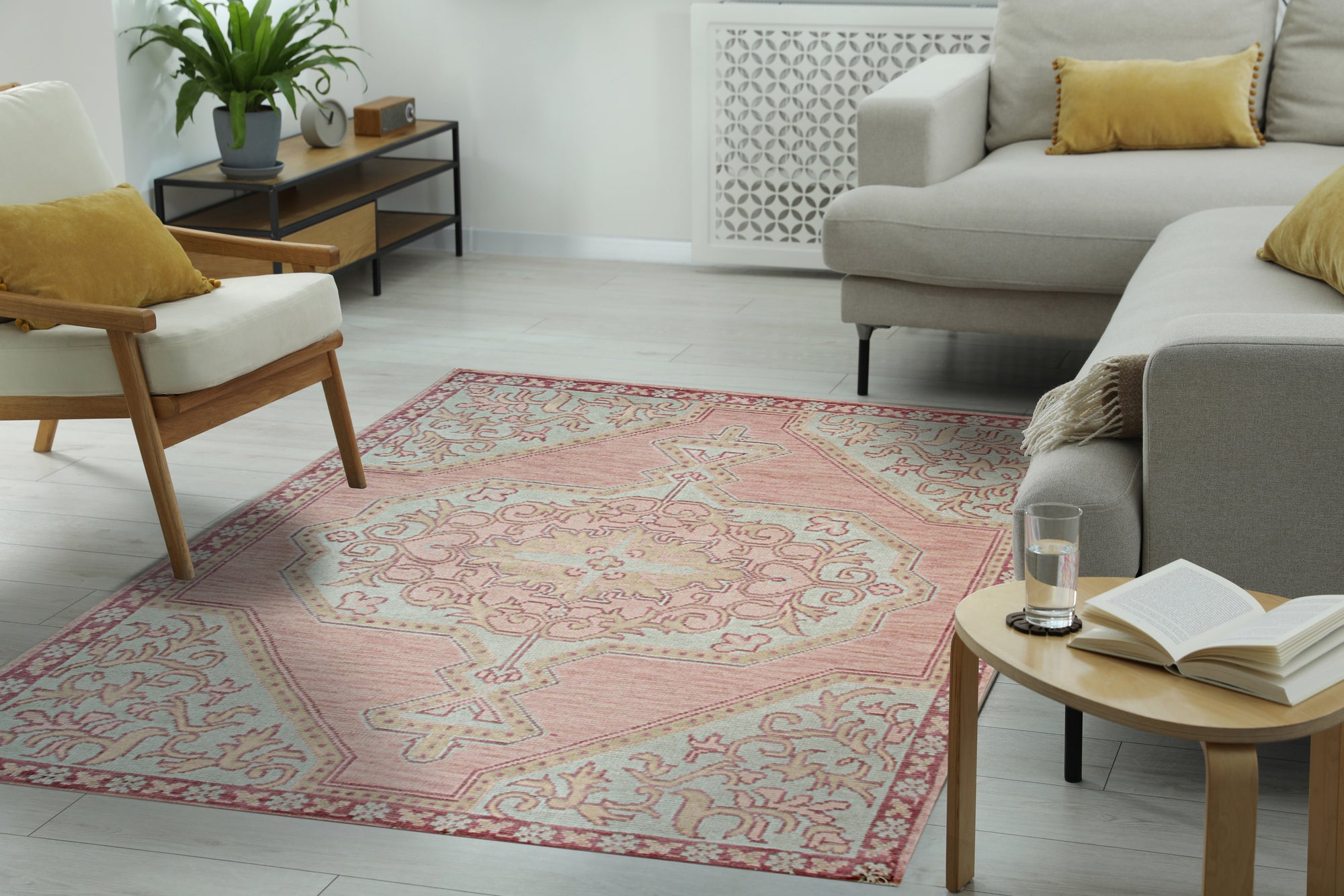 Lydia Oriental Pink Hand Knotted Wool Rug, its intricate floral pattern and soft hues creating a warm, inviting atmosphere in a bright, modern living room setting.