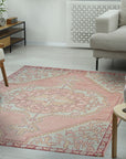 Lydia Oriental Pink Hand Knotted Wool Rug, its intricate floral pattern and soft hues creating a warm, inviting atmosphere in a bright, modern living room setting.