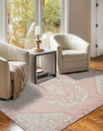 Lydia Oriental Pink Hand Knotted Wool Rug, showcasing a vibrant pink and cream palette with intricate floral and geometric motifs, hand-knotted in wool for luxurious texture and enduring warmth, nestled in a cozy living room setting.