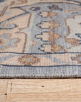 Unique Comfortable Blue Hand Knotted Wool Rug, a calming blue wool rug with intricate hand-knotted detailing, displayed on a light hardwood floor.