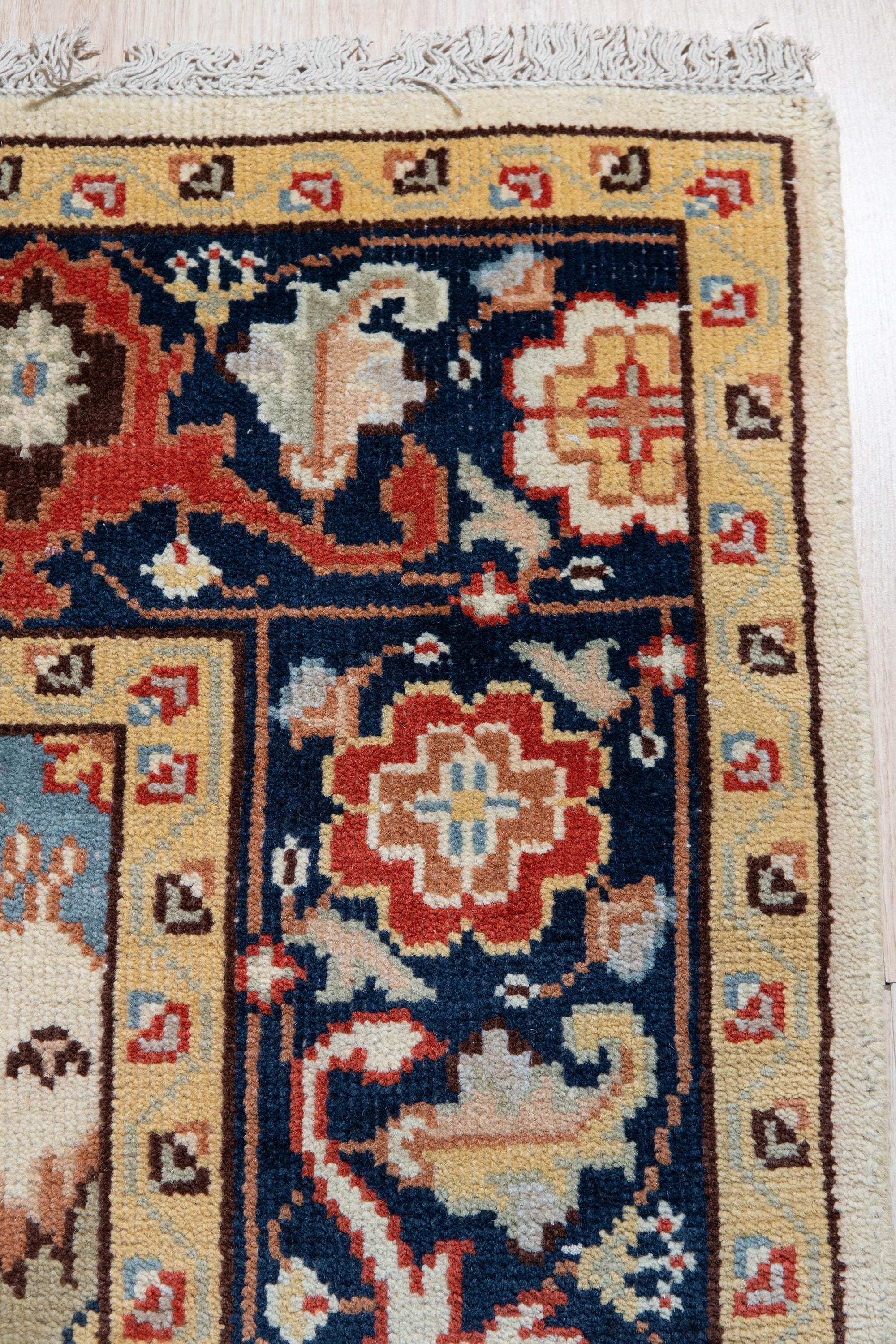 Handcrafted Xena Ivory Hand Knotted Wool Rug, showing intricate details of its hand-knotted construction and subtle ivory hues, displayed in a bright, inviting living room setting.
